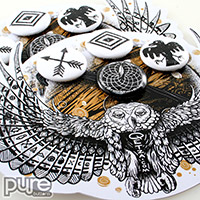 Closeup of Button Packs for Jorge Garza Featuring Four Small Pin-back Buttons